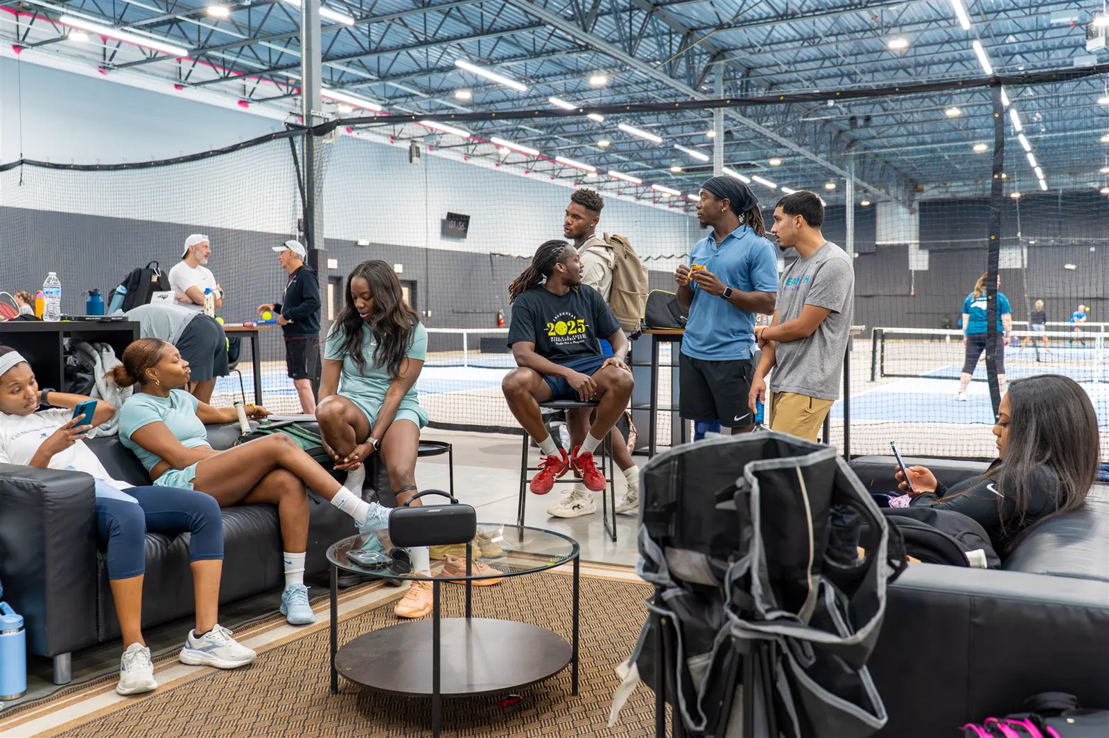 Players and guests gathered near indoor pickleball courts at Carolina Pickleball Club