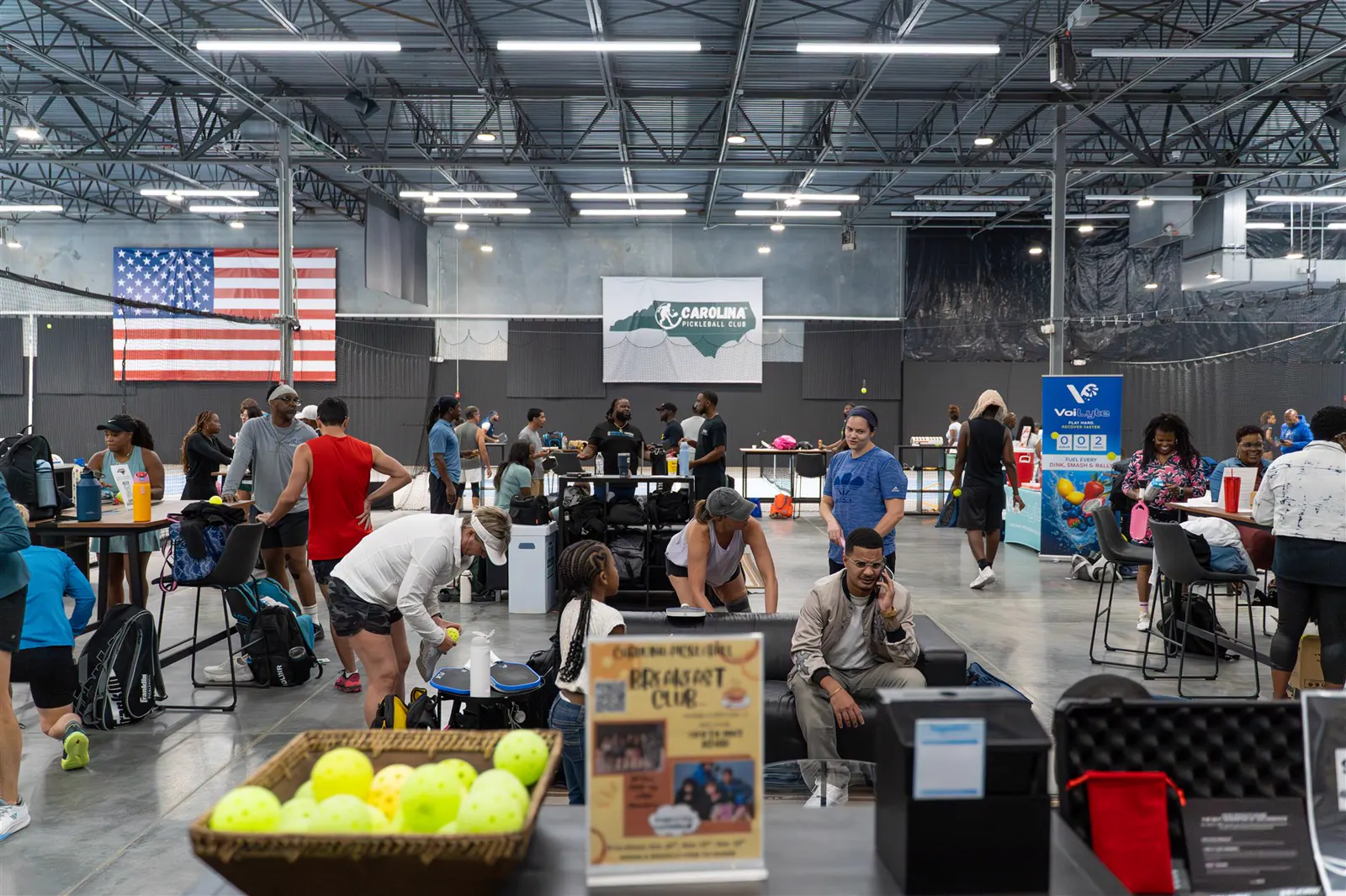 A busy Carolina Pickleball Club event with players and guests gathered around the courts