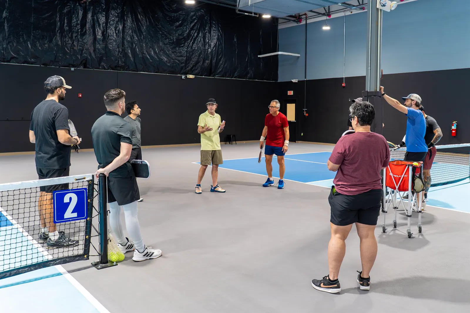 A group listening during a pickleball instruction session